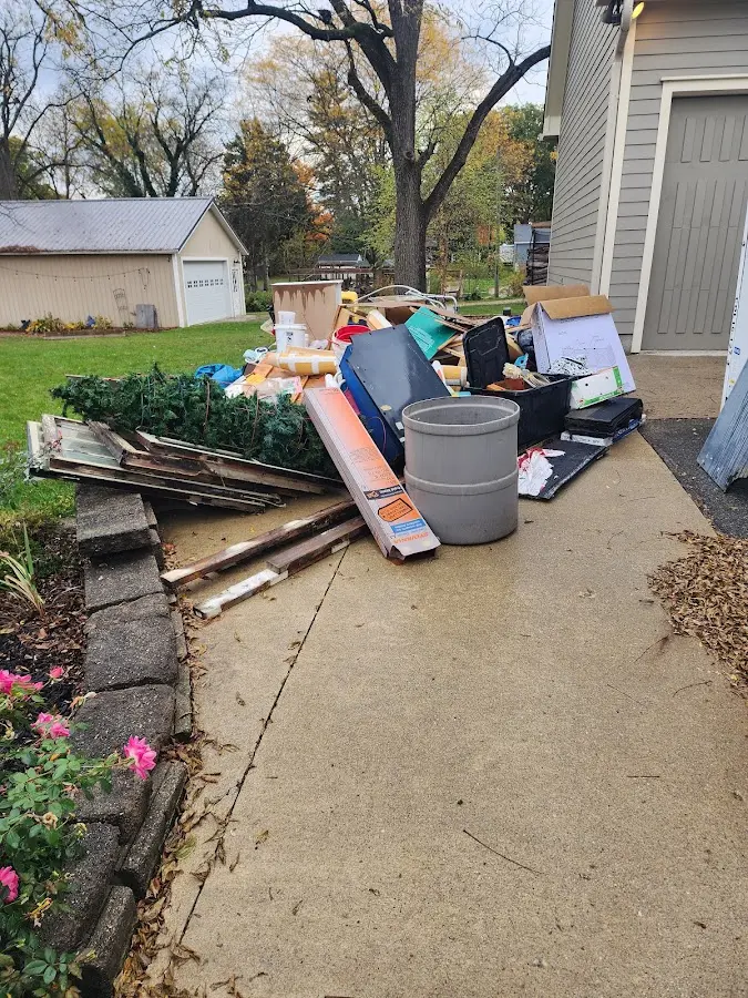 Dumpster being loaded with debris for 10 Yard Dumpster Rental in Stockbridge